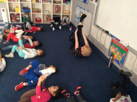 teacher teaxch their student about yoga